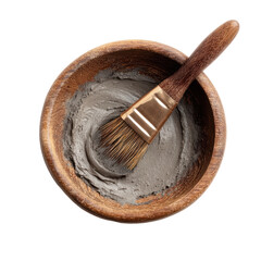 Clay Mask in Wooden Bowl: A close-up studio shot of a wooden bowl filled with gray clay mask and a wooden brush, offering a soothing experience in skin care and wellness.