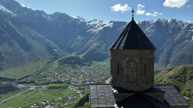 Aerial view of ancient Gergeti Trinity church Tsminda Sameba, near mount Kazbek, a landmark of Georgia, Caucasus mountains. May 26 2025