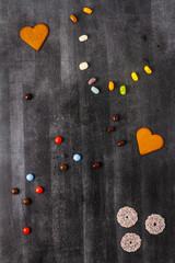 Various sweet food on black chalkboard background. Flat lay. Top view. Food concept.