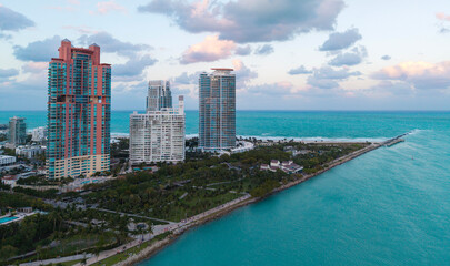 Fototapeta premium Top view of South Miami Beach and the ocean. Miami skyline with skyscrapers. Aerial view of Miami in summer. Miami shore with luxury buildings. Scenic drone view of Miamis famous coastline.