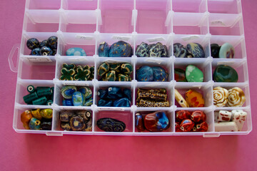 Furniture, beads for diy A neatly arranged box of vibrant gemstones and beads, perfect for crafting...