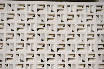 Geometric white wall pattern design with repeating square blocks and interior shadows for