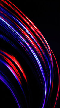 Vibrant red and blue light trails create dynamic curved lines against dark background