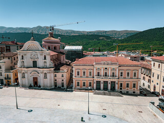 Italy, July 4, 2025: Panoramic aerial view, from the drone, of the Piazza del Duomo in L'Aquila in Abruzzo. Here you can breathe peace and tranquility and history.