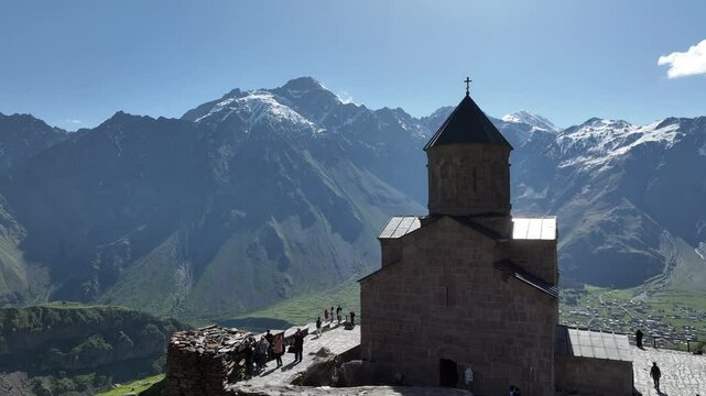 Aerial view of ancient Gergeti Trinity church Tsminda Sameba, near mount Kazbek, a landmark of Georgia, Caucasus mountains. May 26 2025
