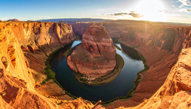 Horseshoe Bend with winding river and red rock canyon walls under bright sunlight in desert landscape