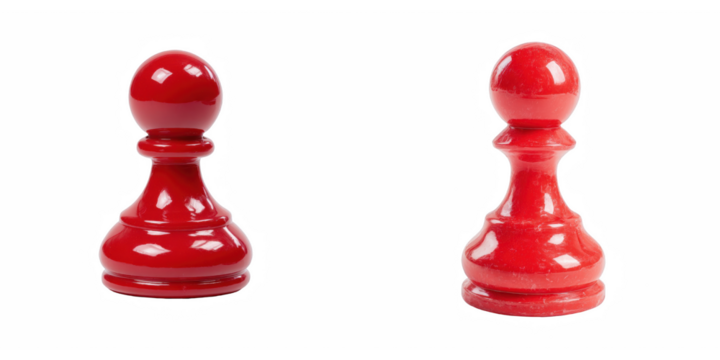 Two red chess pawns isolated on a black background in a studio setting close up view