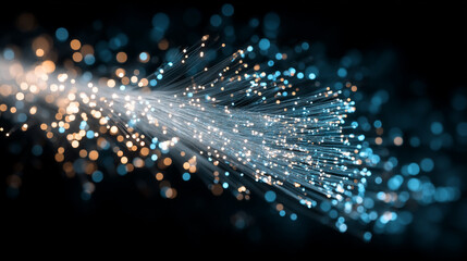 A mesmerizing display of fiber optic cables illuminates the darkness with a burst of vibrant blue and golden light.
