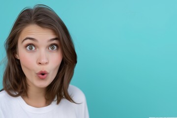Fototapeta premium A close-up view of natural brunette hair with soft waves, accompanied by a simple white shirt, set against a vibrant turquoise background. Minimalistic and clean composition highlighting texture.