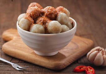 Cilok with spicy peanut sauce, a snack with a chewy and savory texture, with a spicy taste that burns the tongue