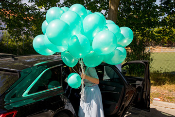 green hot air balloon in the park holding by a person