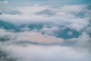 Misty morning landscape with rolling clouds covering mountains in Xindian District New Taipei City Taiwan during spring.