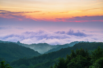 Ethereal morning view of misty mountains in Shilin New Taipei Taiwan, with a faint Taipei City...