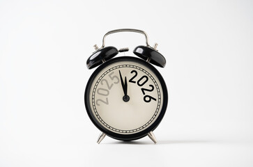 2025 and 2026 on black alarm clock on white background with copy space  for preparation of Merry Christmas and Happy new year