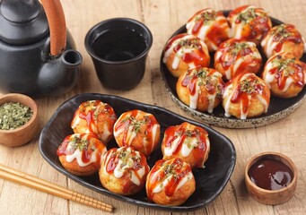 Takoyaki is a typical Japanese snack in the form of small balls made from wheat flour dough and filled with pieces of octopus.