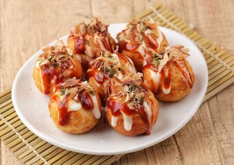 Takoyaki is a typical Japanese snack in the form of small balls made from wheat flour dough and filled with pieces of octopus.