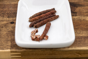 Stick pepper on a white plate, very hot and spicy