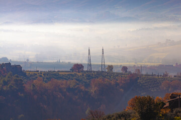Gualdo Cattaneo Country Misty morning in rural countryside with warm autumn colors and isolated houses