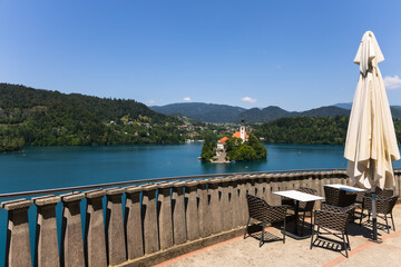 Viewpoint at Lake Bled, Slovenia. Terrace cafe overlooking the bright blue lake surrounded by lush green hills. Destination theme. Summer