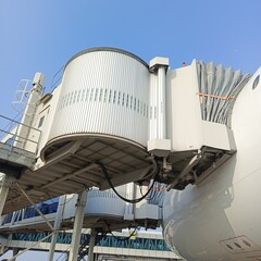 Passenger boarding bridge or garbarata in the aircraft parking area for passengers and aircraft...