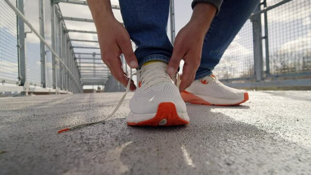 Running Shoes Highlighted In Close Detail As Hands Tighten Shoelaces In Preparation For A Refreshing City Workout On A Warm Summer Day.