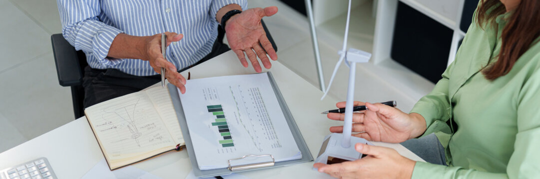 Corporate sustainability discussion with business professionals examining renewable energy and ESG initiatives