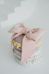 two macaron cookies of different colors wrapped with ribbon on a white isolated background for...
