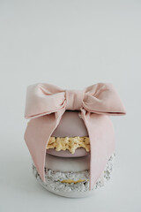 two macaron cookies wrapped with ribbon on a white isolated background