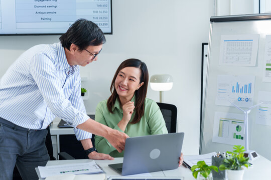 Collaborative Business Meeting Analyzing ESG Performance Data for Sustainable Growth Strategy