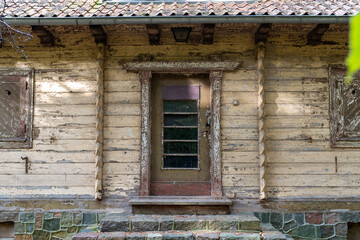 Old wooden door of an abandoned rustic house – editorial use only

