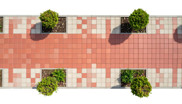 Red and white tiled walkway with green bushes casting shadows on sunny day - Powered by Adobe