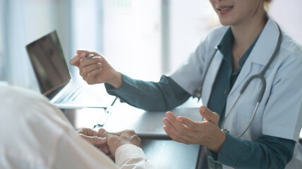 Patient and doctor at desk with support, healthcare at checkup. Female doctor and patient with...