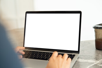 Mockup, laptop computer with blnak white screen. Person working, typing on laptop computer at home...