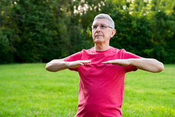 Portrait of mature man while doing sport in city park. Healthy lifestyle concept. Copy space.