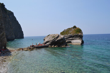 Swimmers Enjoying the Clear Turquoise Waters and Rocky Coastline of Sveti Nikola Island, Montenegro