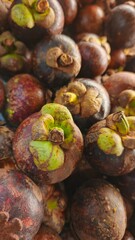 Close up pile of tasty fresh mangosteen sold at the market as a background.