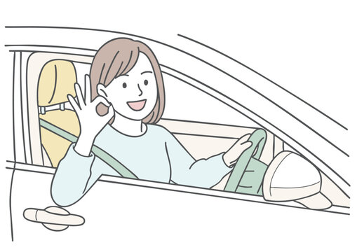 運転中にOKサインを出す笑顔の女性ドライバー