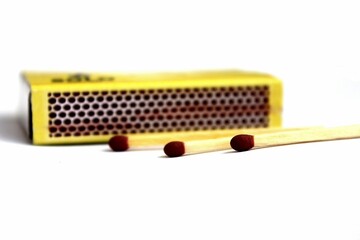 matches for fire. three matches lie near a box on a white background