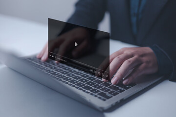 Video streaming on internet concept, Businessman ues laptop to watching and live streaming window,...