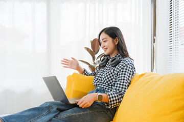 Virtual Connection: A radiant woman is engrossed in a video conference, immersed in an online...