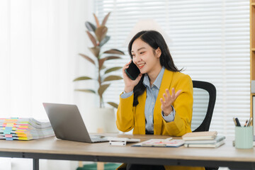Businesswoman at Work: A dynamic businesswoman, engrossed in a phone conversation, navigates her...