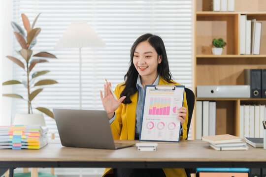 Virtual Collaboration: A bright and professional woman is actively engaged in a virtual business meeting, sharing valuable insights with an open-minded gaze.