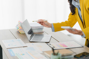 Focused Professional: A focused individual working in an office setting, engrossed in a laptop,...