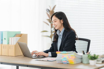 Concentration at Work: A professional woman, focused on her work at her desk. Her dedicated work...