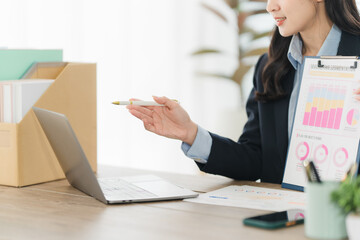 Professional woman at work: A focused businesswoman, pointing to a chart on a clipboard, seamlessly...