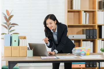 Professional Workspace: A modern workspace showcases an ambitious professional, engrossed in her...