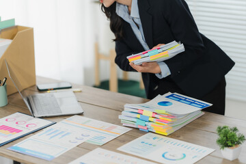 Corporate Paperwork: A dedicated professional meticulously organizes a colorful array of documents...