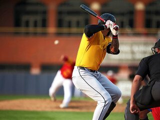 baseball hitter in yellow uniform
