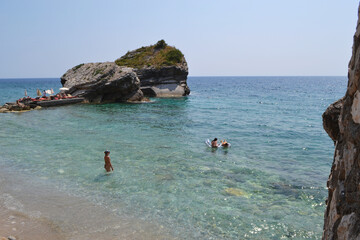 Swimmers Enjoying the Clear Turquoise Waters and Rocky Coastline of Sveti Nikola Island, Montenegro