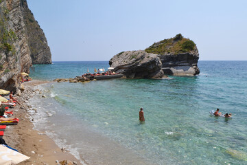 Swimmers Enjoying the Clear Turquoise Waters and Rocky Coastline of Sveti Nikola Island, Montenegro